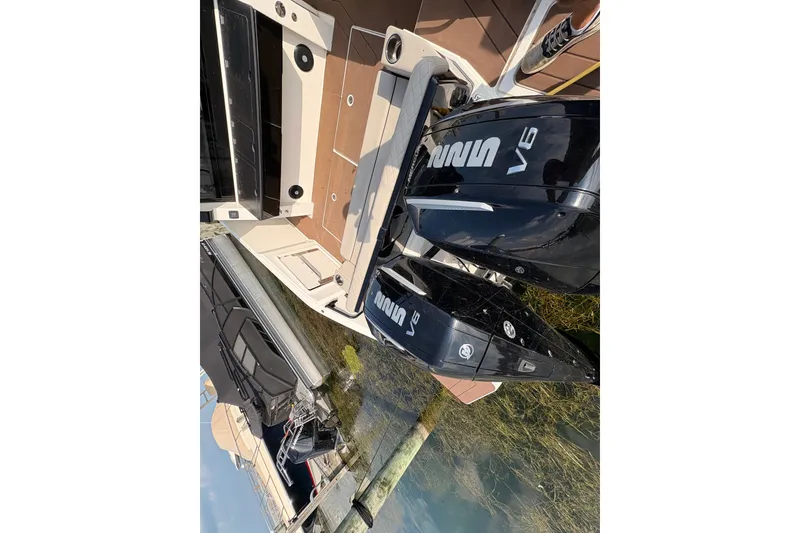 Slide: The Image of 2025 Navan C30 boat with dual V6 outboard engines docked at marina. - 16