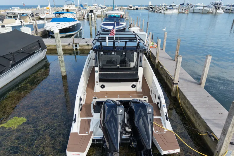 Slide: The Image of 2025 Navan C30 boat docked at marina with dual engines and sleek design. - 21