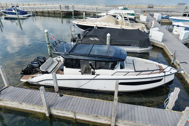 Slide: The Image of 2025 Navan C30 boat docked at marina, featuring sleek design and modern amenities. - 24