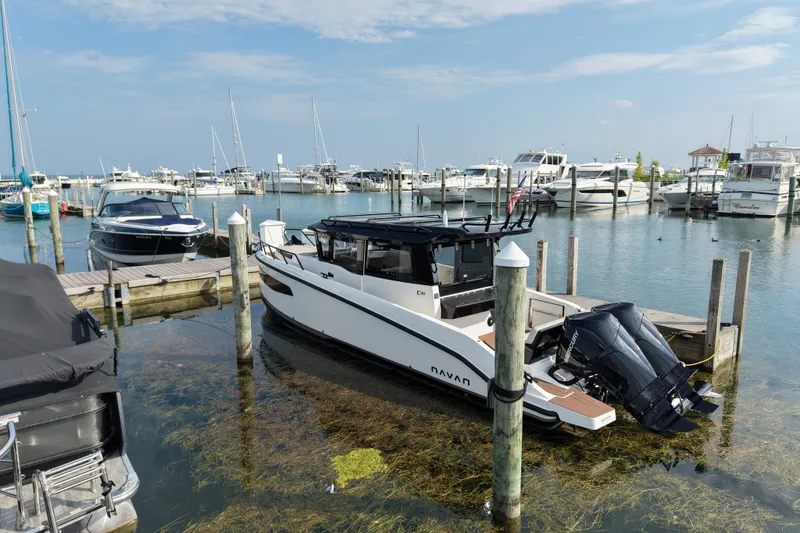 Slide: The Image of Modern 2025 Navan C30 boat docked in a marina with clear blue skies. - 28