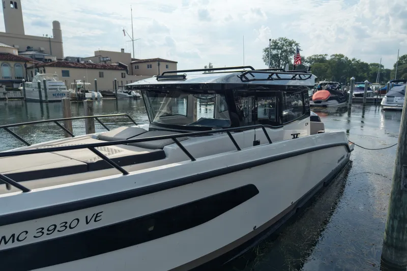 Slide: The Image of 2025 Navan C30 boat docked at a marina, surrounded by other vessels. - 26