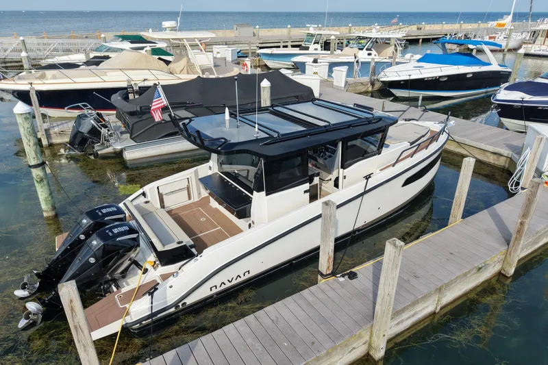 Slide: The Image of Modern 2025 Navan C30 boat docked at marina with dual outboard motors. - 22