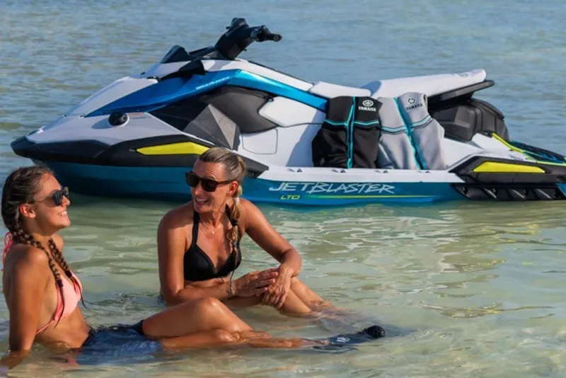 Slide: The Image of Two people relaxing near a 2027 Yamaha WaveRunner JetBlaster LTD in shallow water. - 3