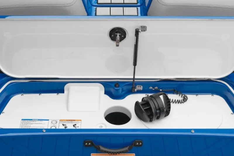 Slide: The Image of Open storage compartment of 2027 Yamaha Boats 205XD, featuring blue and white interior. - 8