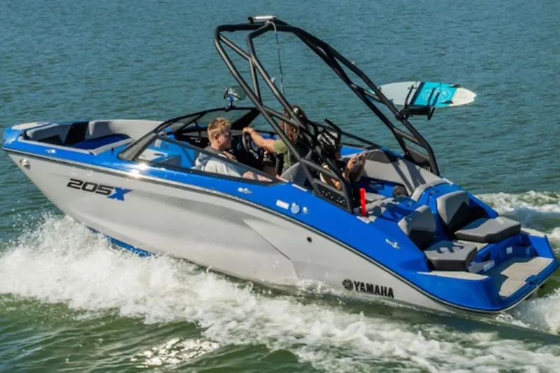 Slide: The Image of 2027 Yamaha Boats 205XD cruising on water with passengers enjoying the ride. - 2