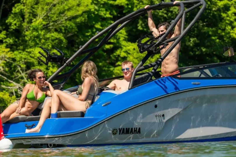 Slide: The Image of People enjoying a sunny day on a 2027 Yamaha Boats 205XD. - 6