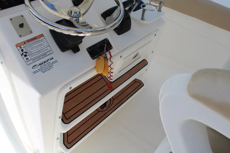 Slide: The Image of 2016 Sea Fox 288 Commander helm with steering wheel and control panel. - 20