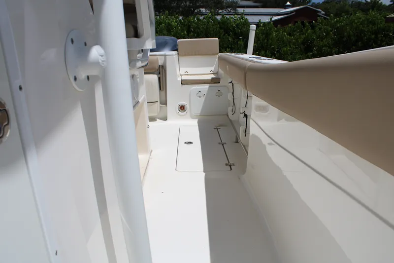 Slide: The Image of 2016 Sea Fox 288 Commander boat interior with beige seating and white deck. - 23