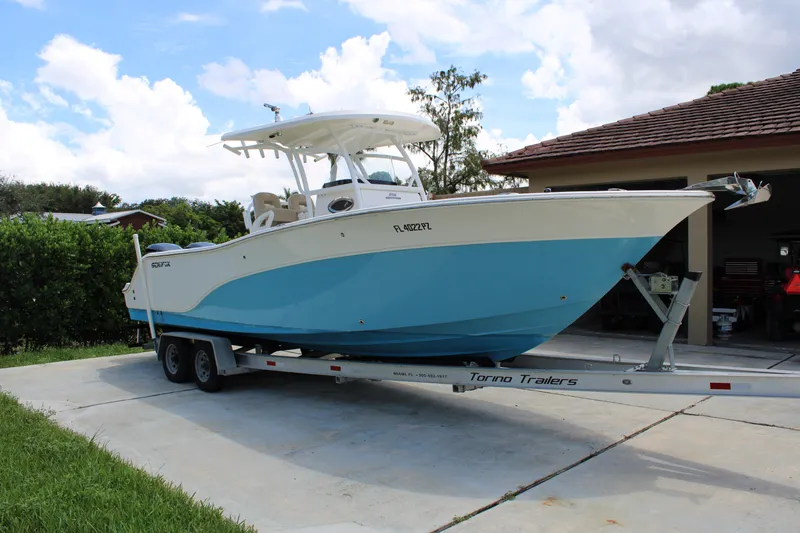 Slide: The Image of 2016 Sea Fox 288 Commander boat on trailer, parked in driveway under blue sky. - 6