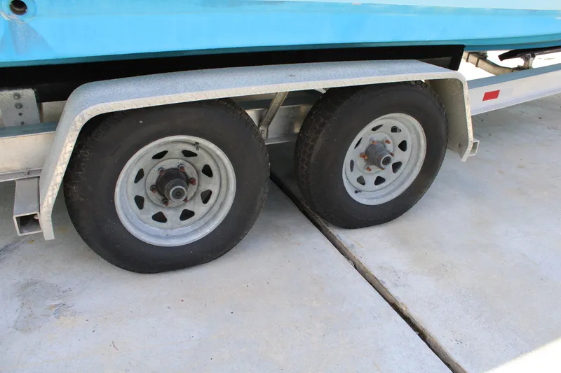 Slide: The Image of Trailer wheels of a 2016 Sea Fox 288 Commander boat on concrete surface. - 38