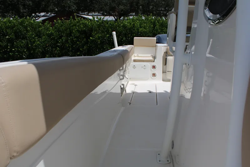 Slide: The Image of 2016 Sea Fox 288 Commander boat interior with beige seating and white deck. - 22
