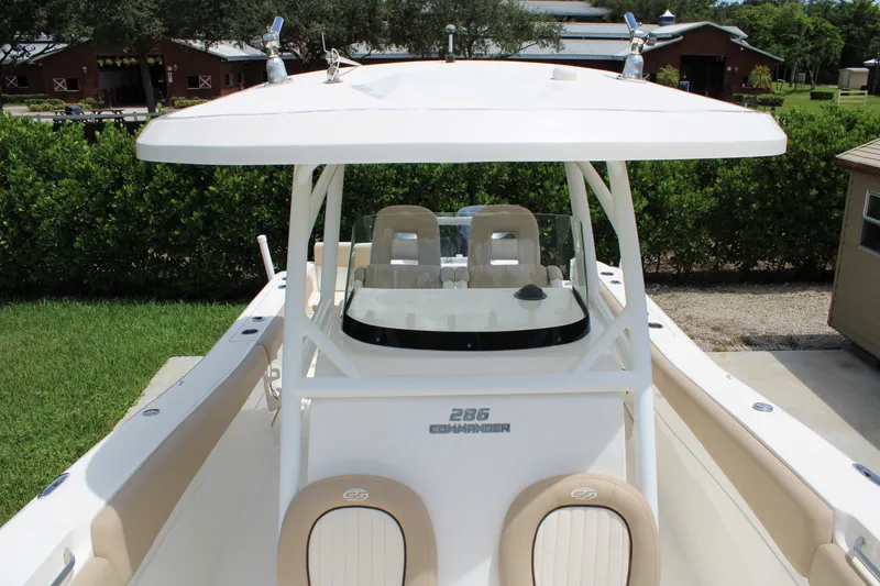Slide: The Image of 2016 Sea Fox 288 Commander boat with dual seating and canopy, docked outdoors. - 14