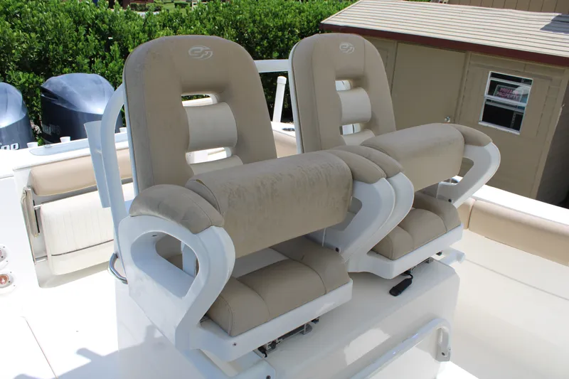 Slide: The Image of 2016 Sea Fox 288 Commander boat seats, beige upholstery, dual outboard motors in background. - 30
