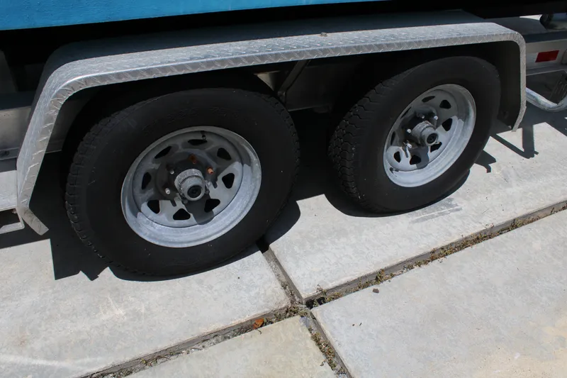 Slide: The Image of Trailer wheels of a 2016 Sea Fox 288 Commander boat on pavement. - 44