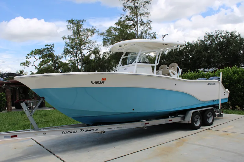 Slide: The Image of 2016 Sea Fox 288 Commander boat on trailer, parked outdoors. - 2