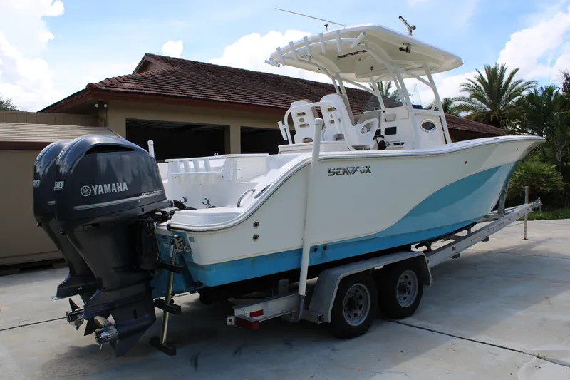 Slide: The Image of 2016 Sea Fox 288 Commander boat on trailer with Yamaha engines, parked outdoors. - 5
