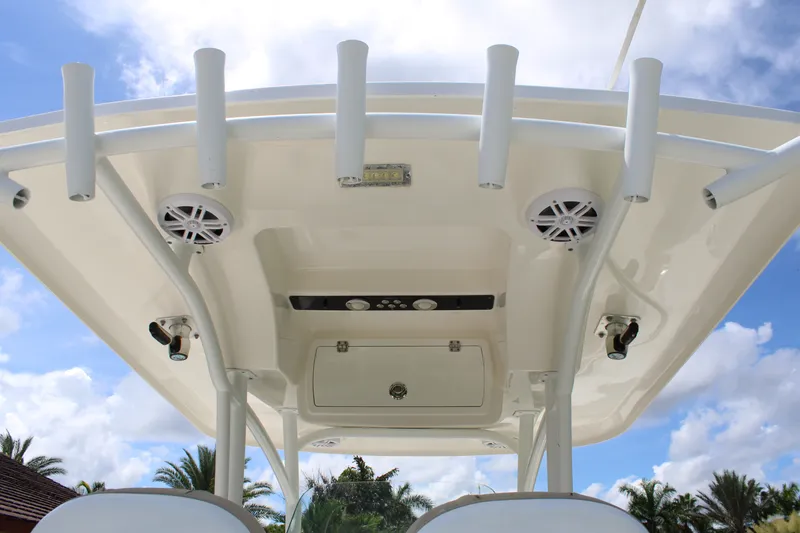 Slide: The Image of 2016 Sea Fox 288 Commander boat roof with rod holders and speakers under blue sky. - 15