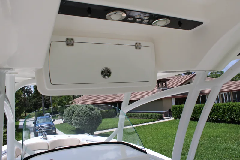 Slide: The Image of 2016 Sea Fox 288 Commander boat interior with overhead storage and control panel. - 19