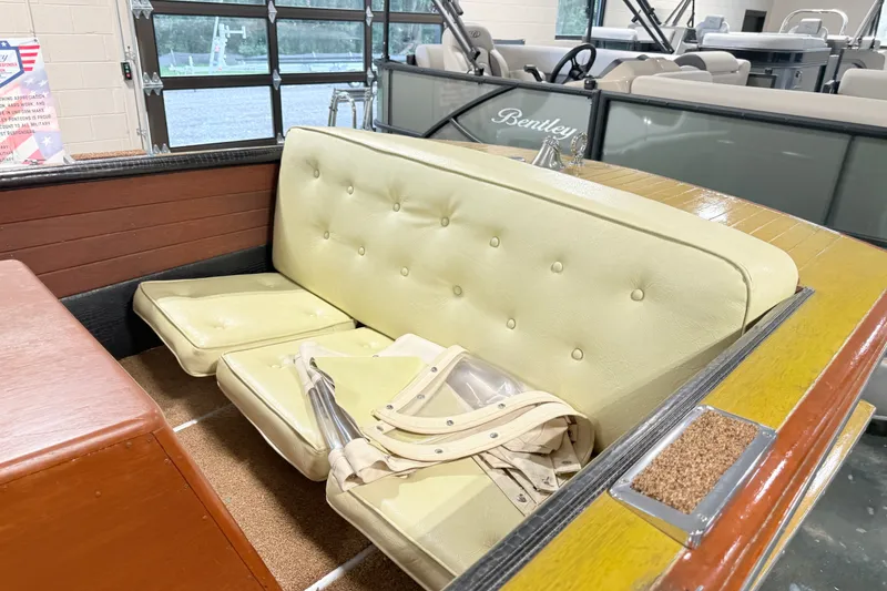 Slide: The Image of 1955 Chris Craft Chriscraft boat interior with beige seating and wooden accents. - 7