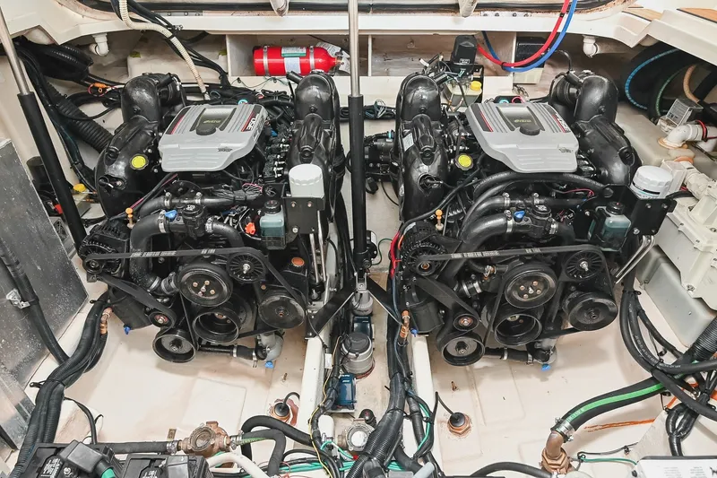 Slide: The Image of Engine room of a 2011 Sea Ray Sundancer 330 with dual engines and fire extinguisher. - 52