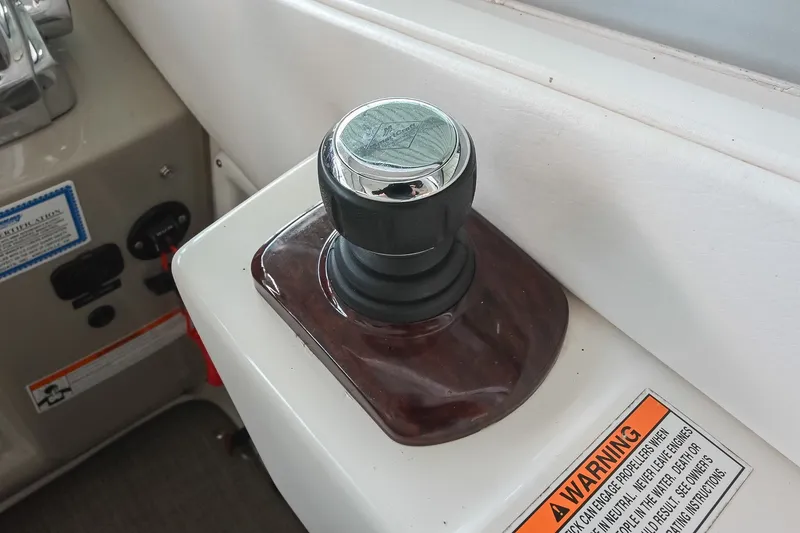 Slide: The Image of Joystick control on a 2011 Sea Ray Sundancer 330 boat dashboard. - 24