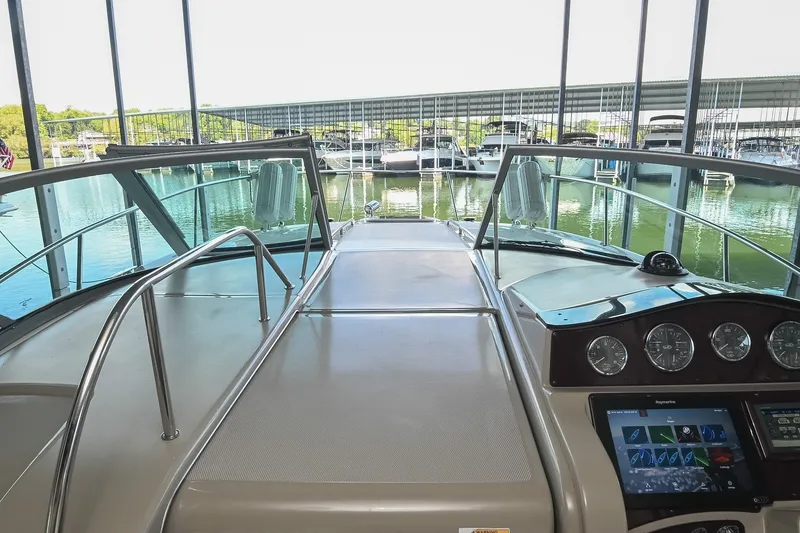 Slide: The Image of 2011 Sea Ray Sundancer 330 helm view in marina setting. - 25