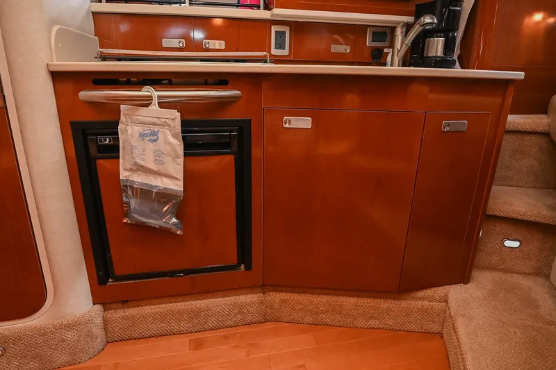 Slide: The Image of 2011 Sea Ray Sundancer 330 galley with wood cabinetry and compact appliances. - 34