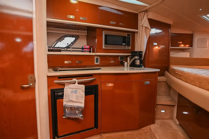 Slide: The Image of Interior of 2011 Sea Ray Sundancer 330 yacht with kitchenette and bed. - 32