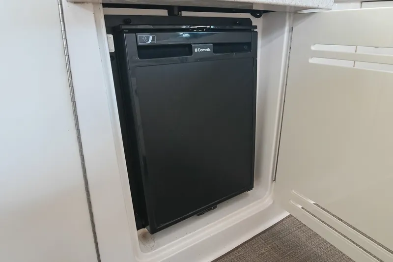 Slide: The Image of Compact Dometic fridge inside 2011 Sea Ray Sundancer 330 yacht cabin. - 14