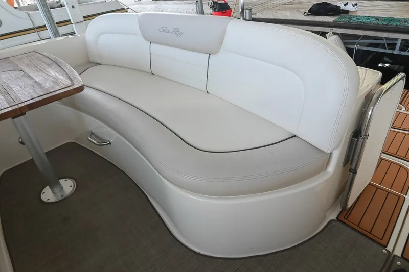 Slide: The Image of 2011 Sea Ray Sundancer 330 interior with white seating and wooden table. - 10