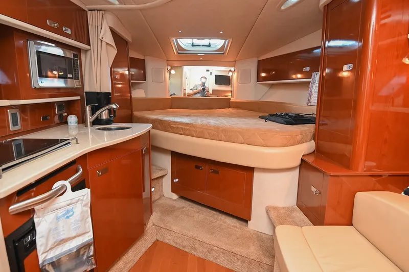 Slide: The Image of Luxurious interior of 2011 Sea Ray Sundancer 330 yacht with cozy bed and kitchenette. - 31