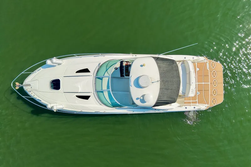 Slide: The Image of Overhead view of 2011 Sea Ray Sundancer 330 yacht on green water. - 16