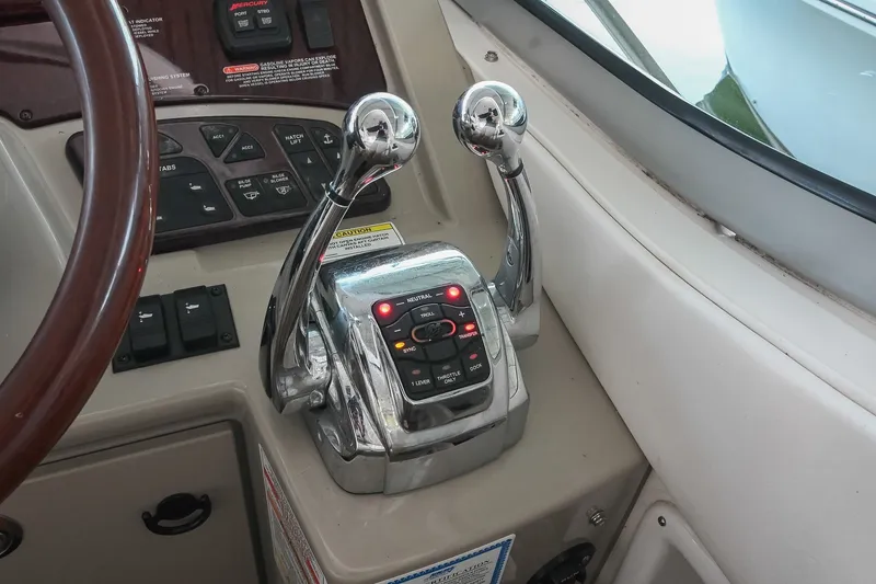 Slide: The Image of Control panel of a 2011 Sea Ray Sundancer 330 boat with throttle levers. - 23