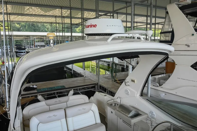 Slide: The Image of 2011 Sea Ray Sundancer 330 yacht docked in a covered marina. - 29