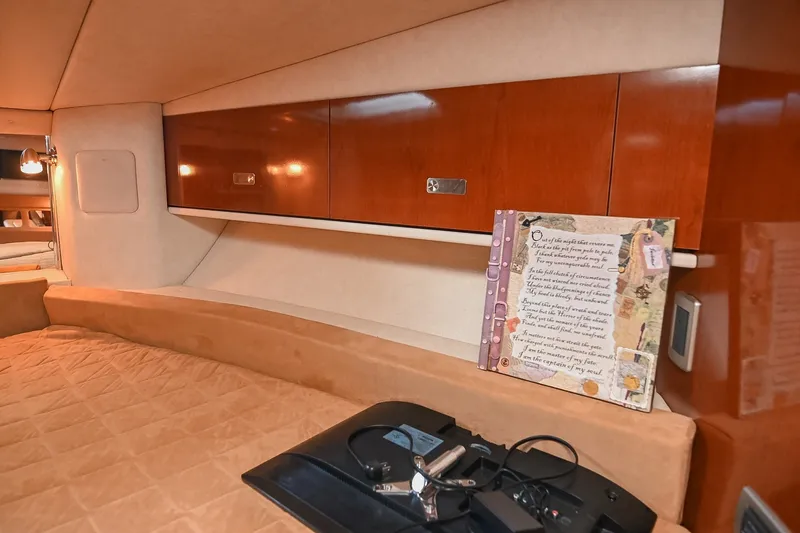 Slide: The Image of Interior cabin of 2011 Sea Ray Sundancer 330 with wooden cabinets and cozy bedding. - 42