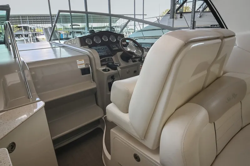 Slide: The Image of Interior view of 2011 Sea Ray Sundancer 330 boat cockpit with steering wheel and seating. - 15