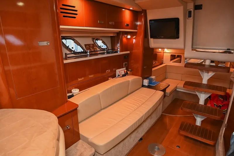 Slide: The Image of Luxurious interior of 2011 Sea Ray Sundancer 330 yacht with plush seating and wooden accents. - 36