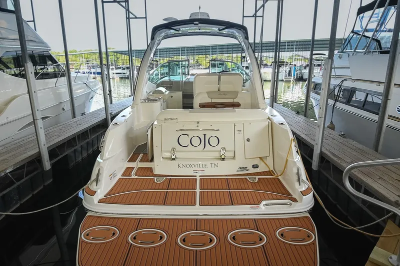 Slide: The Image of 2011 Sea Ray Sundancer 330 docked, featuring teak swim platform and spacious cockpit. - 3