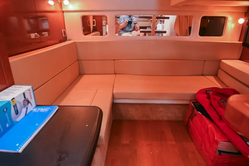 Slide: The Image of Interior of 2011 Sea Ray Sundancer 330 yacht with beige seating and wooden flooring. - 44