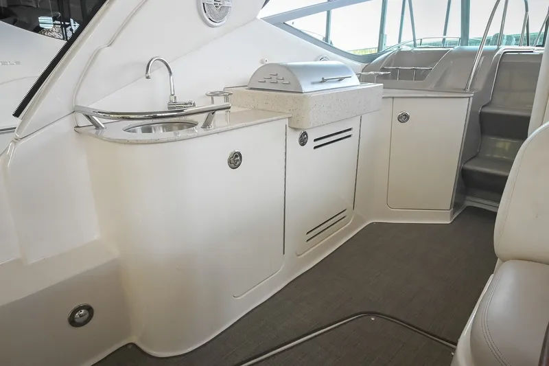 Slide: The Image of 2011 Sea Ray Sundancer 330 yacht interior with kitchenette and sink. - 13
