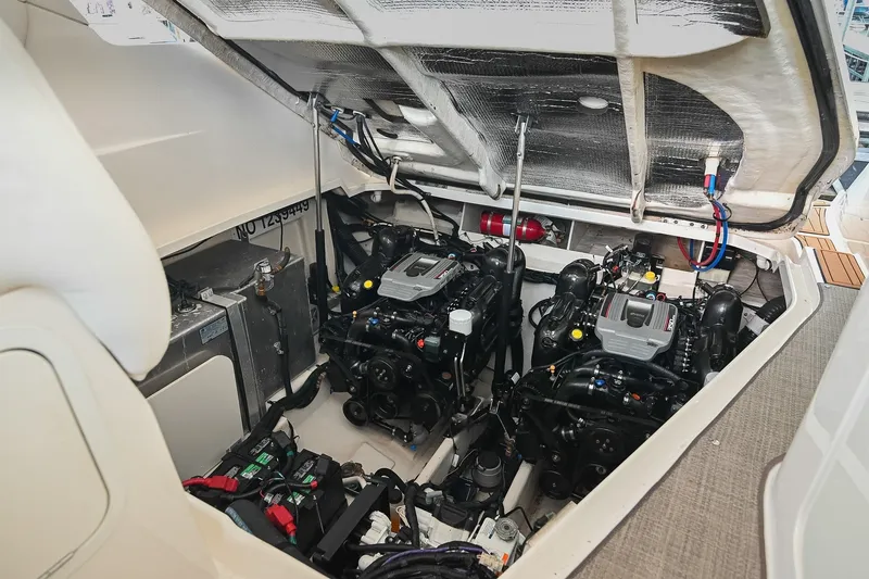 Slide: The Image of Engine compartment of 2011 Sea Ray Sundancer 330 with dual engines and equipment. - 51