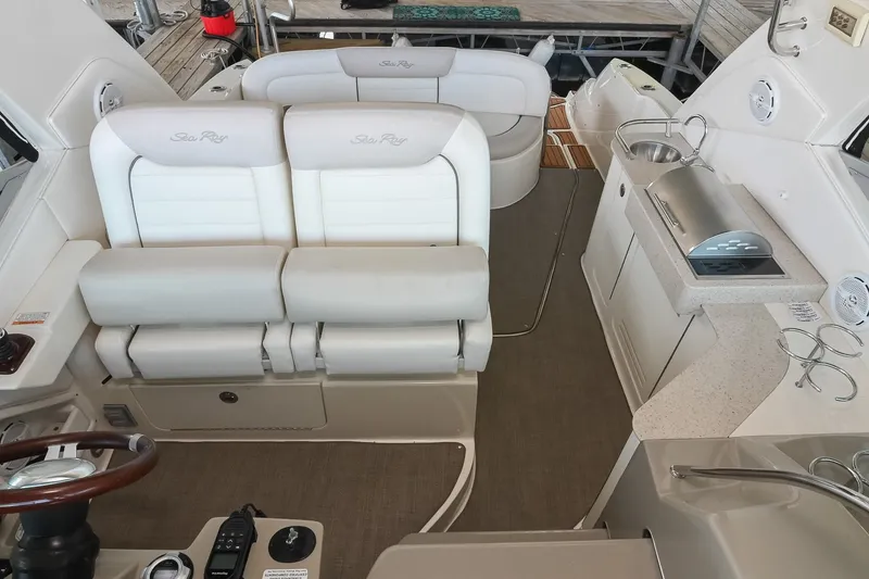 Slide: The Image of Interior of a 2011 Sea Ray Sundancer 330 yacht with seating and kitchenette. - 16