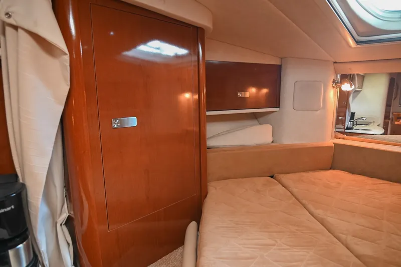 Slide: The Image of Interior cabin of 2011 Sea Ray Sundancer 330 with wood paneling and cozy bedding. - 41