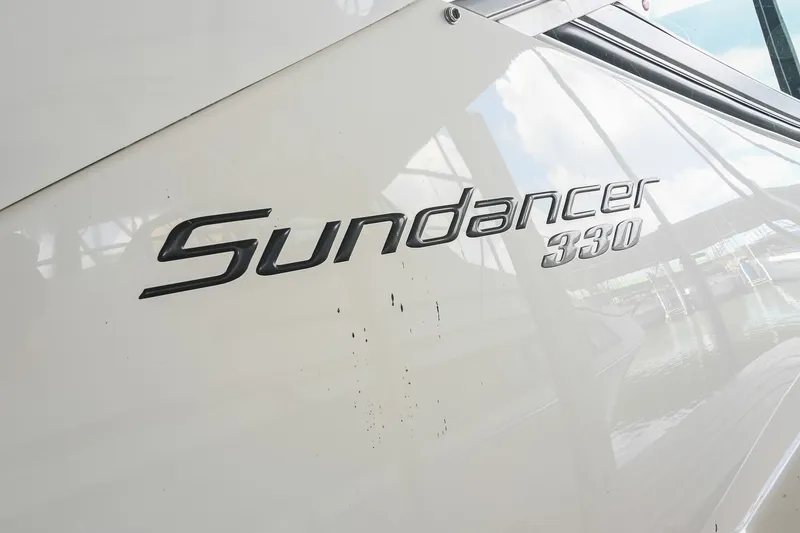 Slide: The Image of Close-up of 2011 Sea Ray Sundancer 330 boat nameplate on white hull. - 2