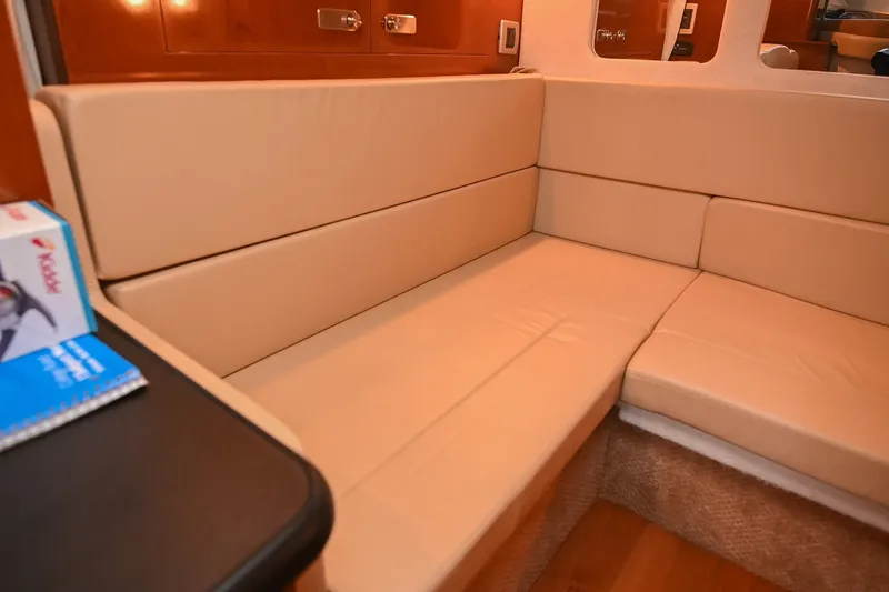 Slide: The Image of Interior seating area of 2011 Sea Ray Sundancer 330 yacht with beige cushions. - 45