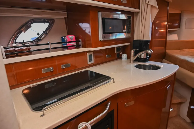 Slide: The Image of Luxurious 2011 Sea Ray Sundancer 330 yacht interior with kitchenette and modern amenities. - 33