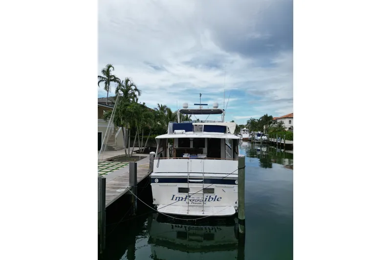 Slide: The Image of 1988 Jefferson Marquessa 60 MY yacht docked in a serene canal setting. - 5
