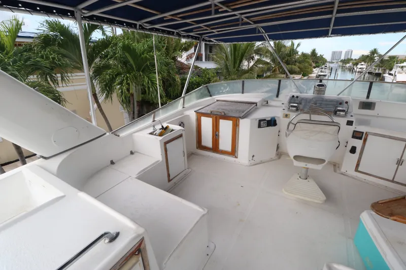 Slide: The Image of Flybridge of 1988 Jefferson Marquessa 60 MY yacht with helm and seating area. - 12