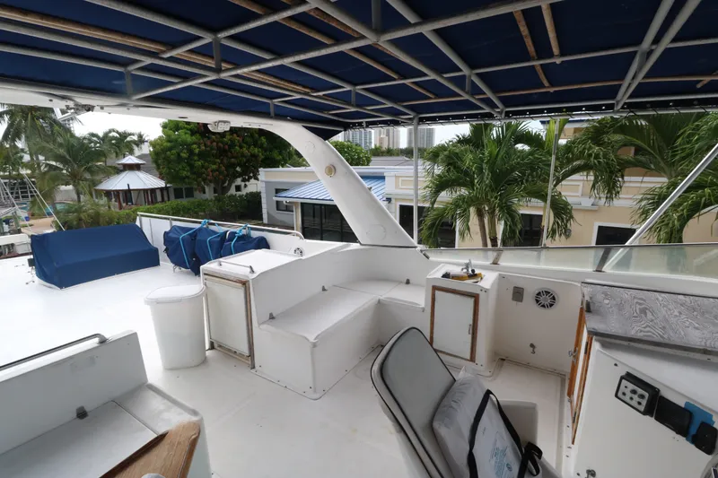 Slide: The Image of 1988 Jefferson Marquessa 60 MY yacht deck with seating, canopy, and tropical backdrop. - 11