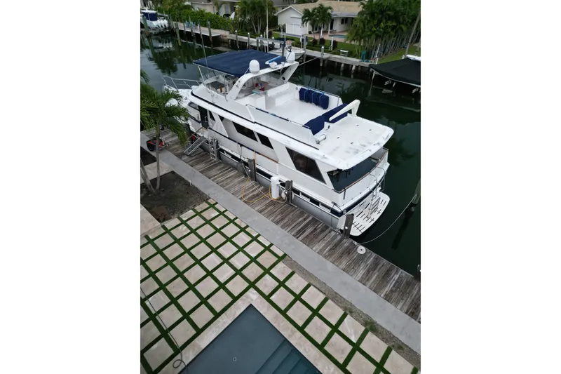 Slide: The Image of 1988 Jefferson Marquessa 60 MY yacht docked by a waterfront home. - 4